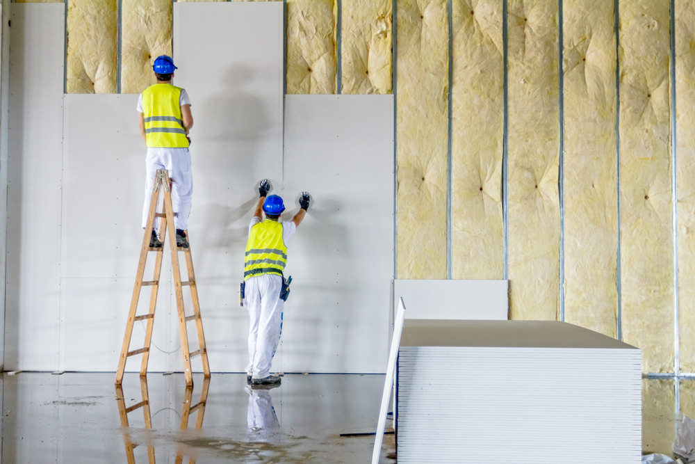 Men putting up drywall