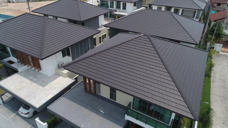 Drak grey roof shingles installed on the roof of multiple houses