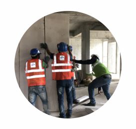 Employees installing readymade concrete wall