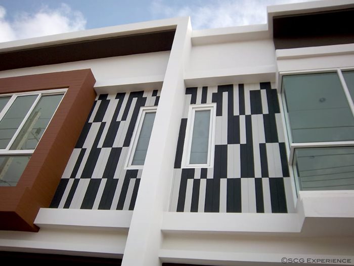 Gouged fiber cement board wall painted in black and white